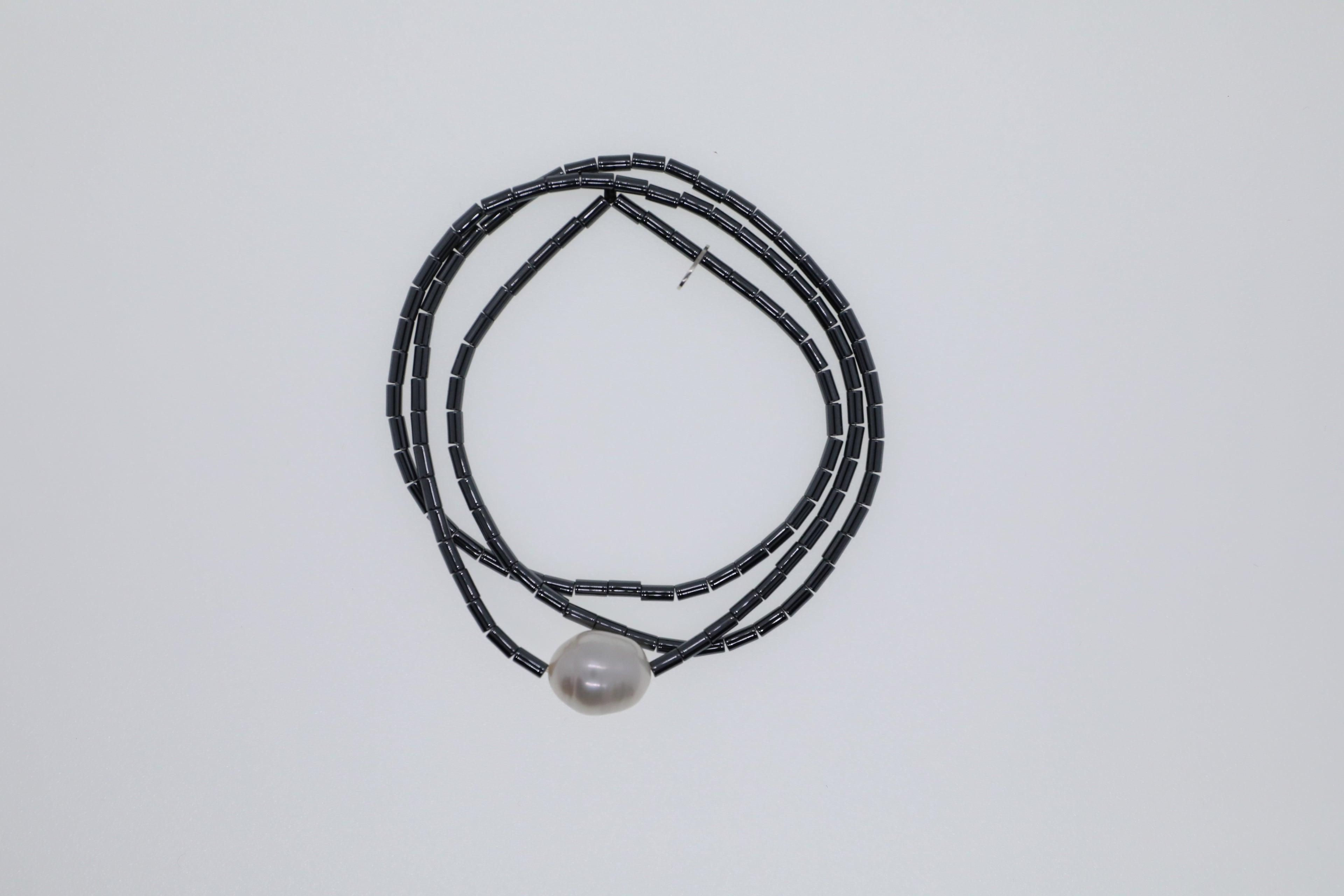 Weiße Süßwasserperle zusammen mit anthrazitfarbenem Hämatit